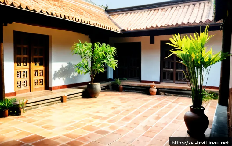 Home 17 전통주택의 마당 정리 방법 - Photorealistic wide view of a tidy Vietnamese traditional courtyard at an old wooden family home, te...